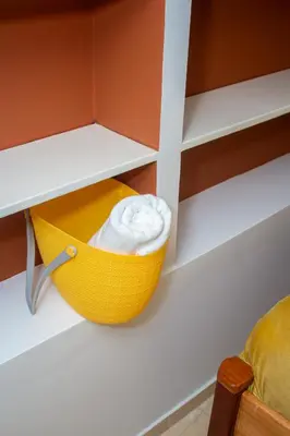 a yellow bowl of whipped cream on a shelf at Studio City Center in Mindelo