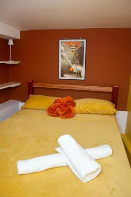 a bed with two towels on top of it at Studio City Center in Mindelo