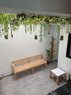 a bench sitting next to a wall with plants at Castro AP in Mindelo