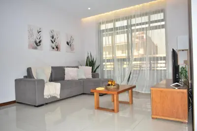 a living room with a couch and a coffee table at Cozy Palm in Praia