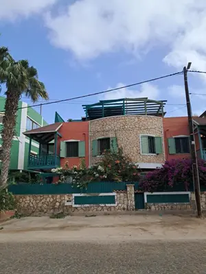 a building with a balcony on top of it at Ibiscus Penthouse in Santa Maria