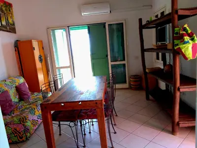 a living room with a wooden table and a couch at Ibiscus Penthouse in Santa Maria