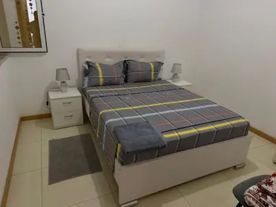 a bedroom with a large bed with two night stands at vitoria in Praia