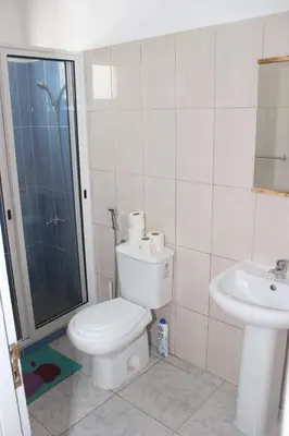 a bathroom with a toilet and a sink at T3 Mindelo in Mindelo