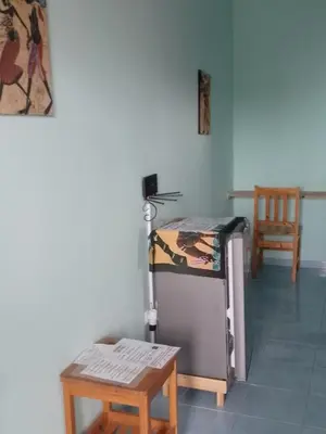 a room with a bed and a table and a chair at Djabraba's kaminhu Double in Vila Nova Sintra