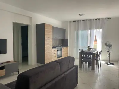 a living room with a couch and a kitchen and a table at Soul of Sal in Santa Maria