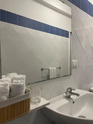 a bathroom with a sink and a mirror and towels at Soul of Sal in Santa Maria