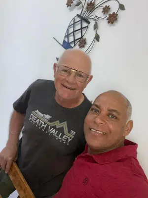 two men are standing next to each other at MONTROND House in São Filipe
