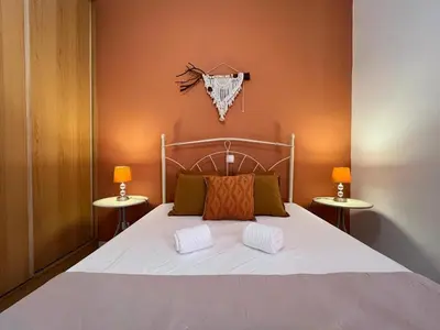 a bedroom with a bed with two side tables at Isabel s Bay in Santa Maria