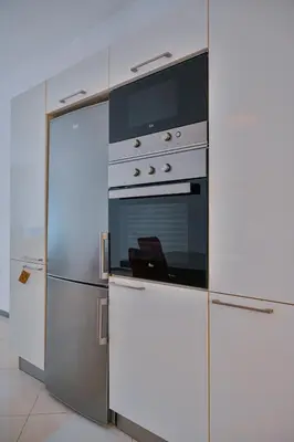 a kitchen with a refrigerator and a stove at Tabanka Azul - 2 BdR Cozy and Comfort Apt Near UN in Praia