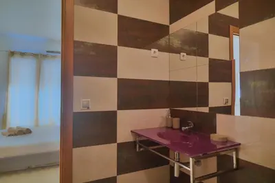 a bathroom with a sink and a mirror at Tabanka Azul - 2 BdR Cozy and Comfort Apt Near UN in Praia