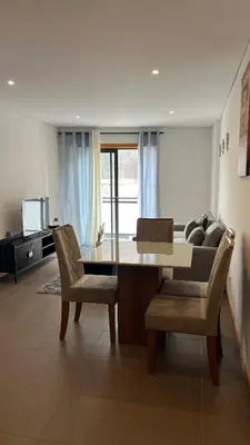 a dining room with a table and chairs and a couch at Elson Apartment - T1 - Cidadela - Security, Comfort in Praia
