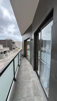 an empty balcony of a building with glass windows at Elson Apartment - T1 - Cidadela - Security, Comfort in Praia