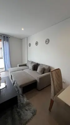 a living room with a couch and a table at Elson Apartment - T1 - Cidadela - Security, Comfort in Praia