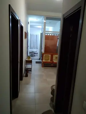a hallway with a living room with a couch at Apartamento T3 em Alto Miramar in Mindelo