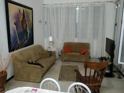 a living room with a couch and a chair at Apartamento T3 em Alto Miramar in Mindelo