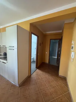 a kitchen with a refrigerator and a tile floor at Holiday Properties Tropicana in Santa Maria