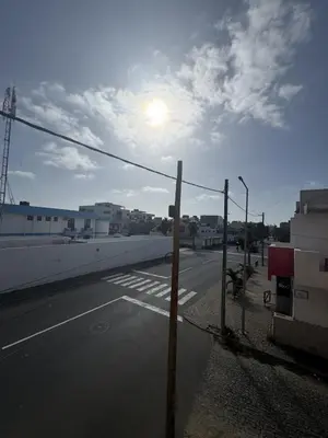 an empty street with the sun in the sky at Holiday Properties Tropicana in Santa Maria