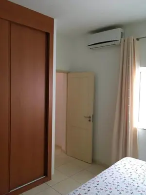 a bedroom with a door and a window and a bed at Duplex Avenida Ilhéu Santa Maria, Palmarejo in Praia