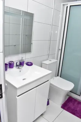 a white bathroom with a sink and a toilet at Modern 2 bedroom apartment in Achada Santo António Praia'' Perto praca Di Nos