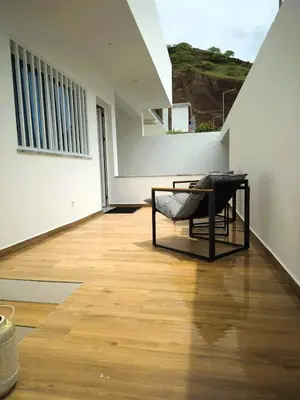 a room with a chair on a wooden floor at Casa strella in Praia