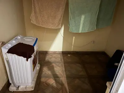 a laundry room with a radiator and some towels at Gamboa t2 in Praia