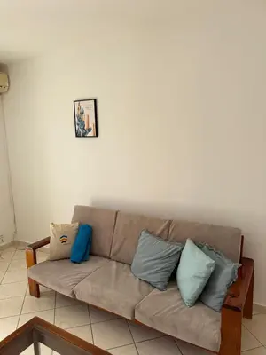 a couch with pillows sitting in a living room at Murdeira V159D Duplex by RPG Group in Beirona