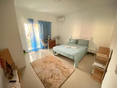 a small bedroom with a bed and a rug at Guest house B&S in Praia