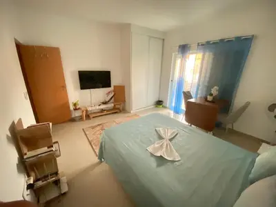 a bedroom with a bed with a bow on it at Guest house B&S in Praia