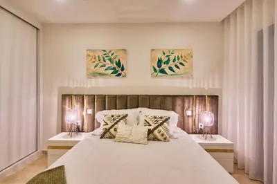 a bedroom with a large bed with two night stands at Sal Sol & Mar - Flor de Sal in Santa Maria
