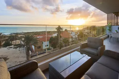 a living room with a view of the ocean at Sal Sol & Mar - Larimar in Santa Maria
