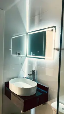 a bathroom with a white sink and a mirror at Prestige Apartment in Praia