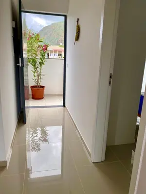 a hallway with a glass door and a potted plant at Casa Uta in Tarrafal