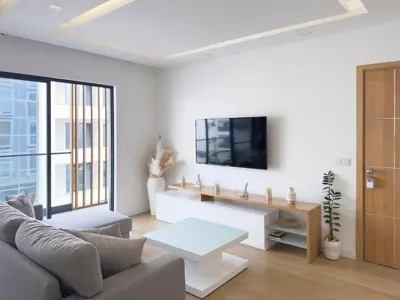 a living room with a couch and a tv on a wall at Cozy 1-bdr apt, Cidadela - LCGR in Praia