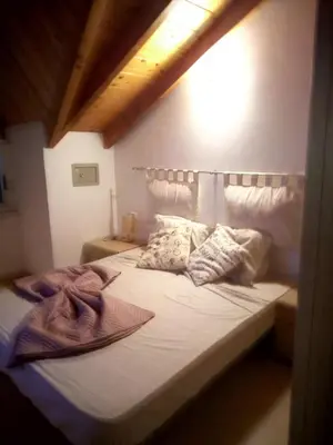 a bedroom with a bed with white sheets and pillows at Soleil A5 - Lovely and central apartment in Santa Maria