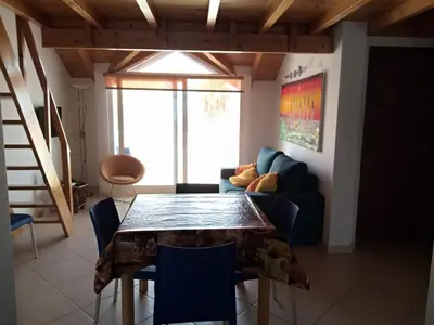 a living room with a table and a couch at Soleil A5 - Lovely and central apartment in Santa Maria