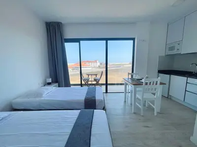 a bedroom with two beds and a table with a view at Studio Medsal in Santa Maria