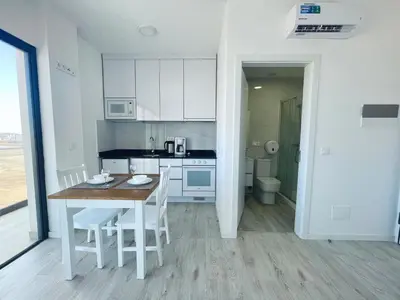 a kitchen with a table and chairs in a room at Studio Medsal in Santa Maria