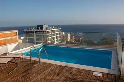 a swimming pool on the balcony of a building at Fresh One Apartment in Praia