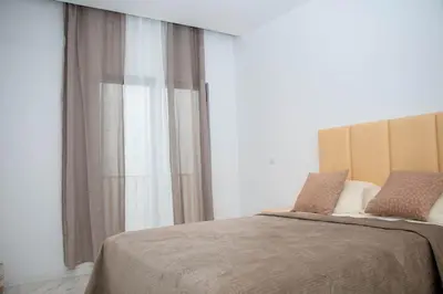 a bedroom with a bed with a large window at Fresh One Apartment in Praia