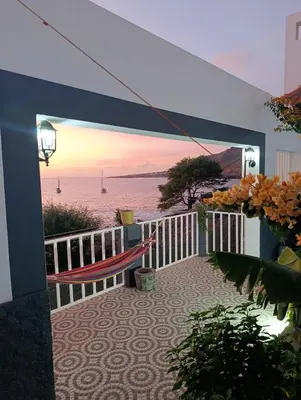 a balcony with a hammock and a view of the ocean at B&B Casa Boho
