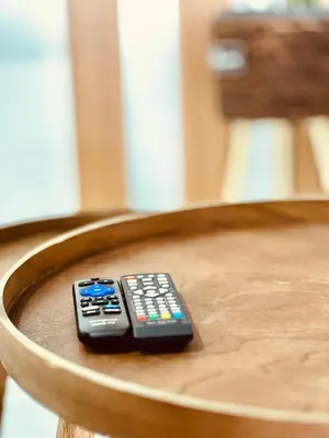 a remote control sitting on top of a wooden chair at Salinas Breeze in Santa Maria