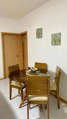 a dining room with a glass table and chairs at Airport Residence - Vila Acácia I in Praia