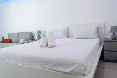 a white bed with white sheets and pillows at Yes Rooftop, Private Pool & Sea View, Cidadela in Praia