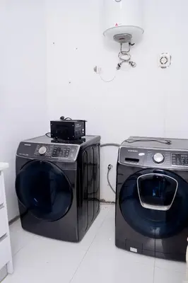 two washing machines sitting next to each other in a room at Kretxeu Luxury Villa in Praia