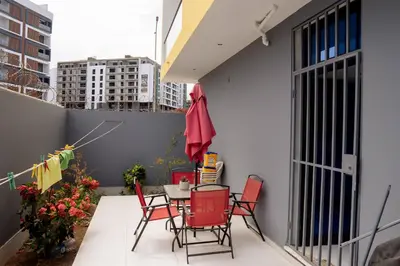 a patio with chairs and a table on a balcony at Kretxeu Luxury Villa in Praia