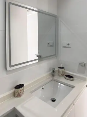 a white bathroom with a sink and a mirror at 2-bdr bright apt central street cidadela - LCGR in Praia