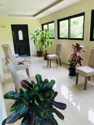 a living room with tables and chairs and plants at Residencial Palice