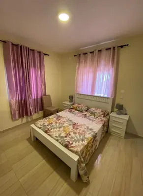a bedroom with a bed and pink curtains at Residencial Palice