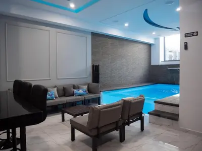 a room with a swimming pool with a couch and a piano at Top-Level Pool in Praia